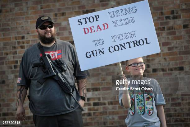 James Everard and his son Steven join a group advocating for the rights of gun owners, as they stage a counter-protest near a March for Our Lives...