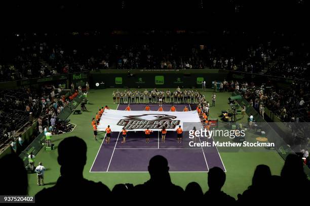 Players, ball kids and students from the tennis team of Marjory Stoneman Douglas High School participate in a ceremony in tribute to the victims of a...