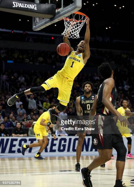 Charles Matthews of the Michigan Wolverines dunks the ball in the first half against the Florida State Seminoles in the 2018 NCAA Men's Basketball...