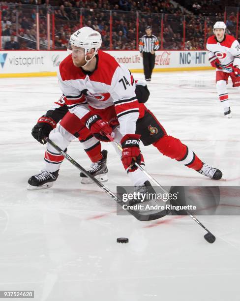 Jaccob Slavin of the Carolina Hurricanes controls the puck against Zack Smith of the Ottawa Senators at Canadian Tire Centre on March 24, 2018 in...