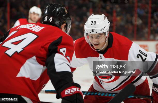 Sebastian Aho of the Carolina Hurricanes talks with Jean-Gabriel Pageau of the Ottawa Senators as they prepare for a faceoff at Canadian Tire Centre...