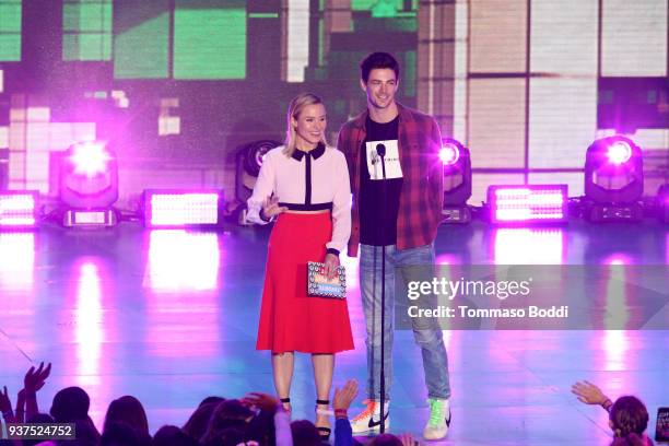 Kristen Bell and Grant Gustin speak onstage at Nickelodeon's 2018 Kids' Choice Awards at The Forum on March 24, 2018 in Inglewood, California.