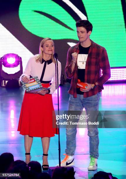 Kristen Bell and Grant Gustin speak onstage at Nickelodeon's 2018 Kids' Choice Awards at The Forum on March 24, 2018 in Inglewood, California.