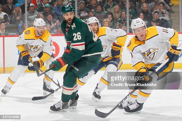 Anthony Bitetto, Yannick Weber and Colton Sissons of the Nashville Predators defend Daniel Winnik of the Minnesota Wild during the game at the Xcel...