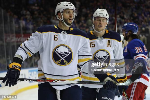 Marco Scandella and Jack Eichel of the Buffalo Sabres react after a goal by the New York Rangers in the second period during their game at Madison...