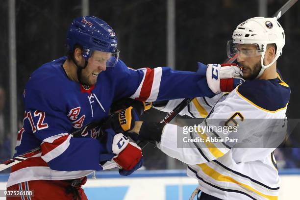 Peter Holland of the New York Rangers and Marco Scandella of the Buffalo Sabres get into a fist fight in the second period during their game at...