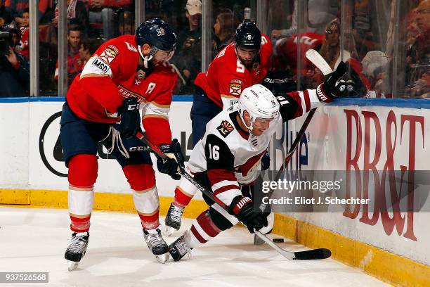 Max Domi of the Arizona Coyotes tangles with Keith Yandle and teammate Aaron Ekblad of the Florida Panthers at the BB&T Center on March 24, 2018 in...