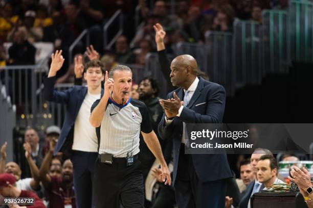 Referee Ken Mauer Interim makes a call as head coach Larry Drew of the Cleveland Cavaliers applauds his team during the first half against the...