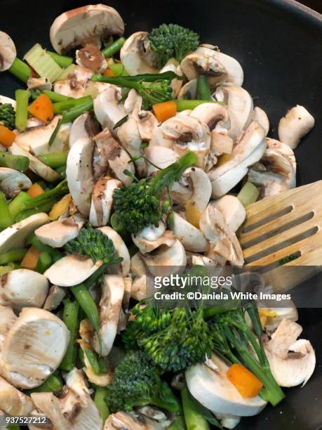 stir frying vegetables in a wok - stir frying european stock pictures, royalty-free photos & images