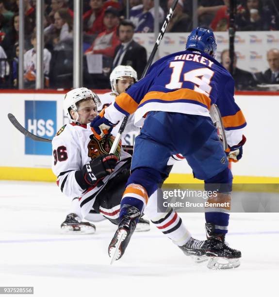 Matthew Highmore of the Chicago Blackhawks is hit by Thomas Hickey of the New York Islanders during the third period at the Barclays Center on March...