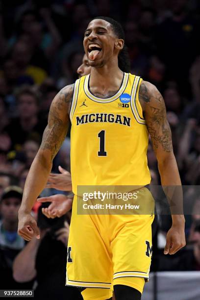 Charles Matthews of the Michigan Wolverines reacts after he dunks the ball in the first half against the Florida State Seminoles in the 2018 NCAA...