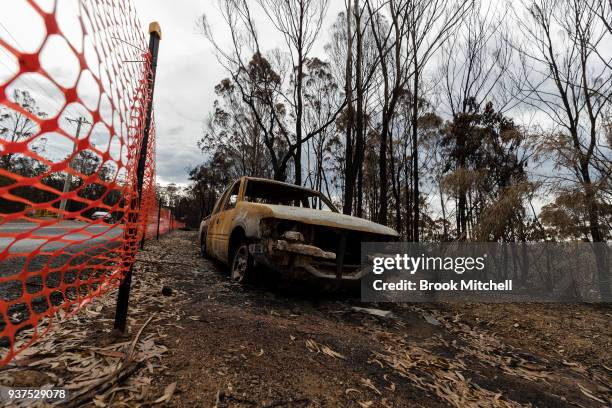 Burnt out vechile is seen on Thompsons Drive on March 25, 2018 in Tathra, Australia. A bushfire which started on 18 March destroyed 65 houses, 35...