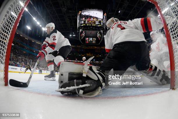 John Moore and Keith Kinkaid of the New Jersey Devils tend the net against the Vegas Golden Knights during the game at T-Mobile Arena on March 14,...