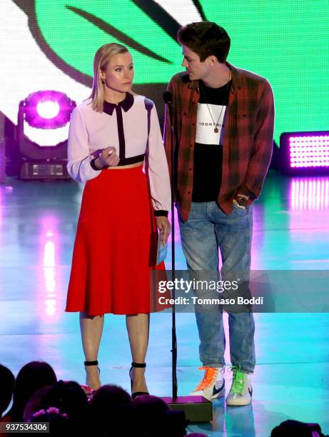 Kristen Bell and Grant Gustin speak onstage at Nickelodeon's 2018 Kids' Choice Awards at The Forum on March 24, 2018 in Inglewood, California.