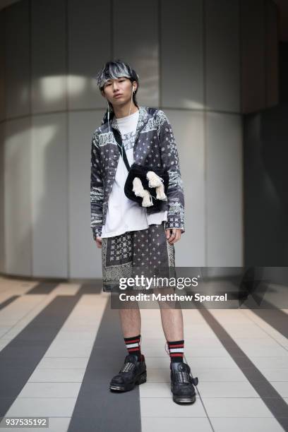 Guest is seen wearing a monochrome outfit including fringe accent bag and sneakers during the Amazon Fashion Week TOKYO 2018 A/W on March 24, 2018 in...