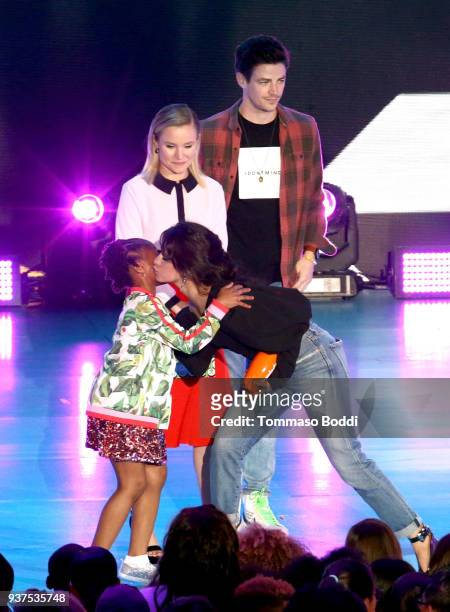 Camila Cabello accepts Favorite Breakout Artist from Kristen Bell and Grant Gustin onstage at Nickelodeon's 2018 Kids' Choice Awards at The Forum on...