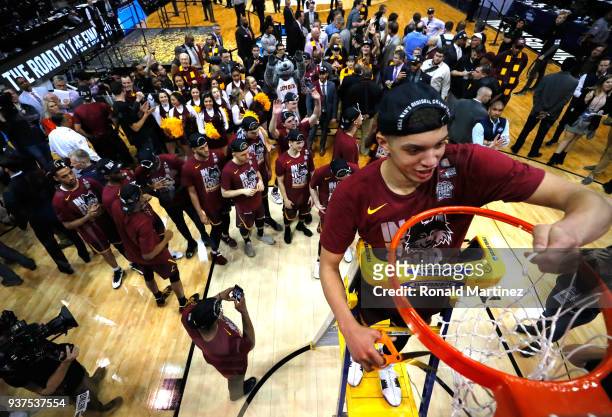 Lucas Williamson of the Loyola Ramblers celebrates by cutting down the net after defeating the Kansas State Wildcats during the 2018 NCAA Men's...