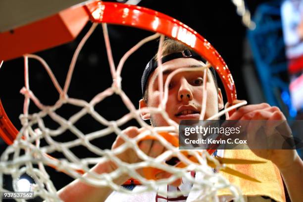 Cameron Krutwig of the Loyola Ramblers celebrates by cutting down the net after defeating the Kansas State Wildcats during the 2018 NCAA Men's...