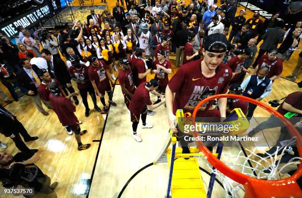 Clayton Custer of the Loyola Ramblers celebrates by cutting down the net after defeating the Kansas State Wildcats during the 2018 NCAA Men's...