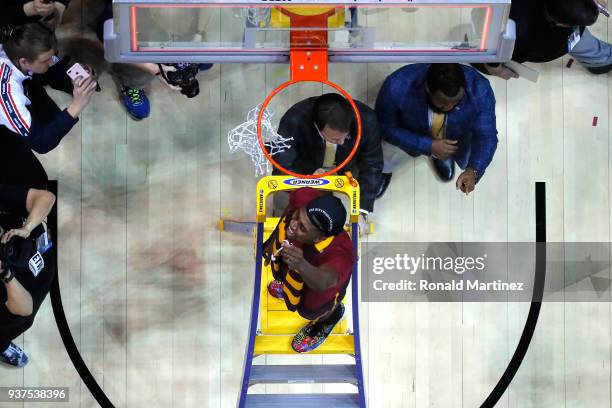 Donte Ingram of the Loyola Ramblers celebrates by cutting down the net after defeating the Kansas State Wildcats during the 2018 NCAA Men's...