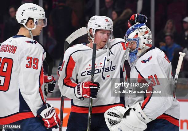 Philipp Grubauer and Nicklas Backstrom of the Washington Capitals celebrate after defeating the Montreal Canadiens in the NHL game at the Bell Centre...