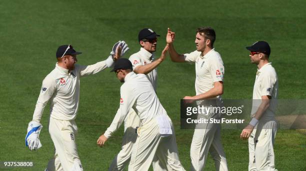 England bowler Craig Overton celebrates with team mates after dismissing Colin de Grandhomme during day four of the First Test Match between the New...