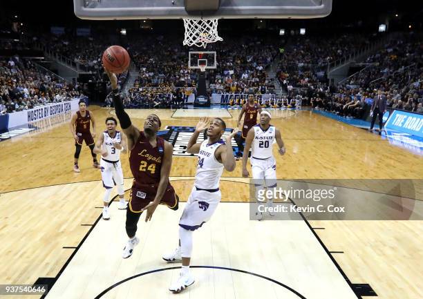 Aundre Jackson of the Loyola Ramblers drives to the basket against Levi Stockard III of the Kansas State Wildcats in the first half during the 2018...