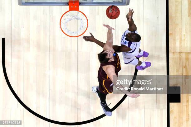 Makol Mawien of the Kansas State Wildcats shoots against Cameron Krutwig of the Loyola Ramblers in the first half during the 2018 NCAA Men's...
