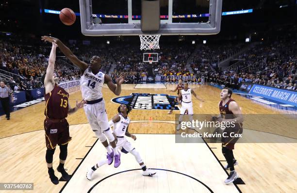 Clayton Custer of the Loyola Ramblers shoots against Makol Mawien of the Kansas State Wildcats in the first half during the 2018 NCAA Men's...