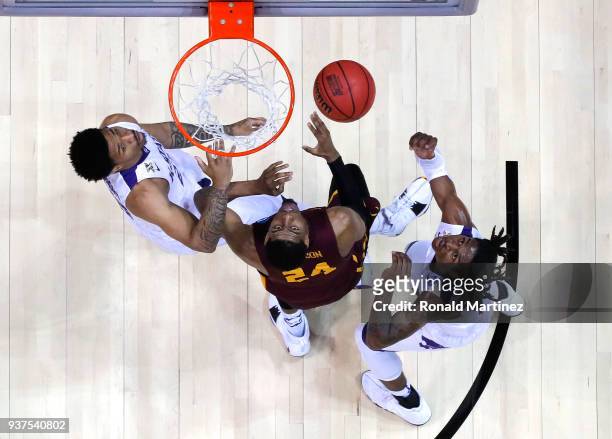 Aundre Jackson of the Loyola Ramblers competes for a rebound with Levi Stockard III and Cartier Diarra of the Kansas State Wildcats in the second...