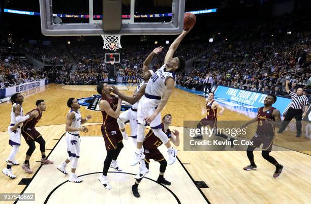 Mike McGuirl of the Kansas State Wildcats goes up with the ball in the second half against Lucas Williamson of the Loyola Ramblers during the 2018...