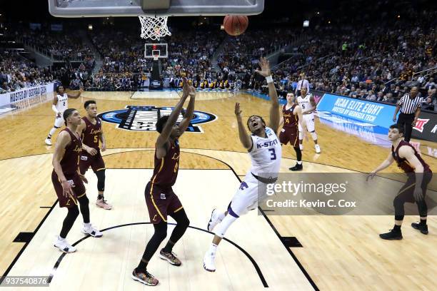 Kamau Stokes of the Kansas State Wildcats shoots against Donte Ingram of the Loyola Ramblers in the second half during the 2018 NCAA Men's Basketball...