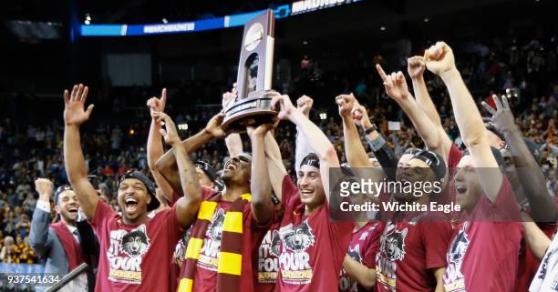 Loyola hoists the South Regional trophy after defeating Kansas State, 78-62, in an NCAA Tournament regional final at Philips Arena in Atlanta on...