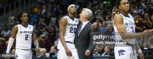 Kansas State's Xavier Sneed is hugged by head coach Bruce Weber as the Wildcats check out of the game against Loyola in an NCAA Tournament regional...