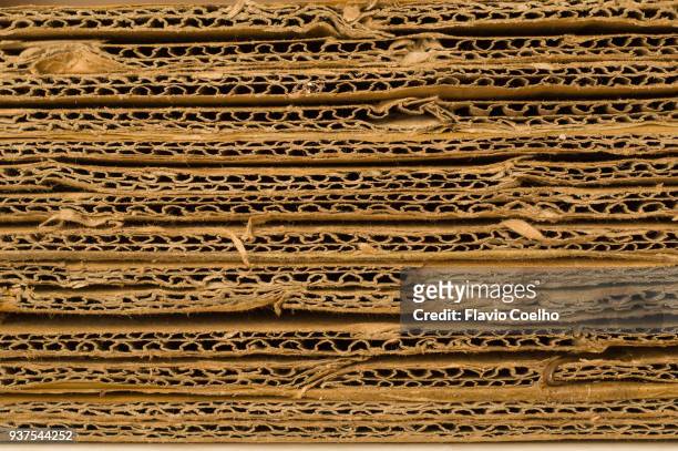 stack of used corrugated cardboard for recycling - paperboard stockfoto's en -beelden