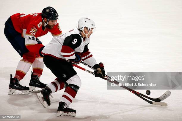 Clayton Keller of the Arizona Coyotes skates with the puck against Aaron Ekblad of the Florida Panthers at the BB&T Center on March 24, 2018 in...