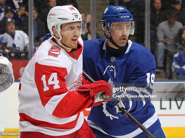 Gustav Nyquist of the Detroit Red Wings skates against Tomas Plekanec of the Toronto Maple Leafs during an NHL game at the Air Canada Centre on March...