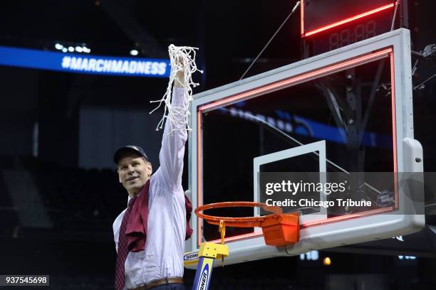 Loyola head coach Porter Moser hoists the net after a 78-62 win against Kansas State in an NCAA Tournament regional final at Philips Arena in Atlanta...