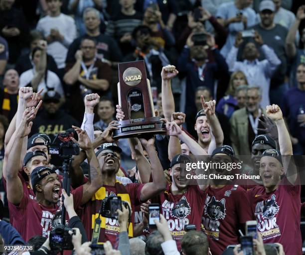 The Loyola Ramblers celebrate after a 78-62 win against Kansas State in an NCAA Tournament regional final at Philips Arena in Atlanta on Saturday,...