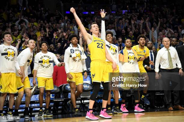 Duncan Robinson of the Michigan Wolverines reacts in front of the bench as he makes a three-pointer in the second half while taking on the Florida...