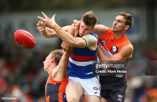 Billy Gowers of the Bulldogs and Jeremy Finlayson of the Giants contest possession during the round one AFL match between the Greater Western Sydney...