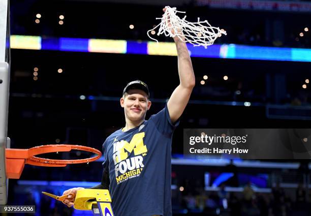 Moritz Wagner of the Michigan Wolverines cuts down the net after the Wolverines 58-54 victory against the Florida State Seminoles in the 2018 NCAA...