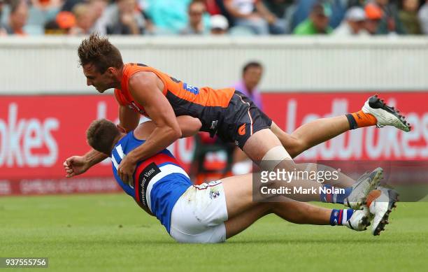 Jeremy Finlayson of the Giants tackles Jack Macrae of the Bulldogs during the round one AFL match between the Greater Western Sydney Giants and the...
