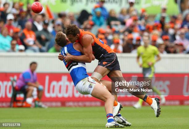 Jeremy Finlayson of the Giants tackles Jack Macrae of the Bulldogs during the round one AFL match between the Greater Western Sydney Giants and the...