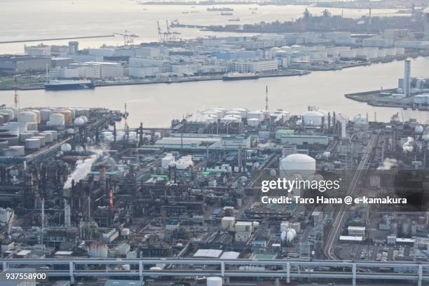 tokyo bay, oil stockpile bases and chimneys factory area in kawasaki city in kanagawa prefecture in japan daytime aerial view from airplane - kanagawa prefecture stock pictures, royalty-free photos & images