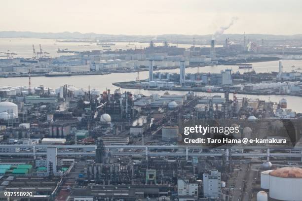 tokyo bay, oil stockpile bases and chimneys factory area in kawasaki city in kanagawa prefecture in japan daytime aerial view from airplane - kawasaki stock pictures, royalty-free photos & images