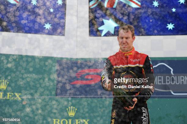 Race winner David Reynolds driver of the Erebus Penrite Racing Holden Commodore ZB celebrates on the podium during race 4 for the Supercars...