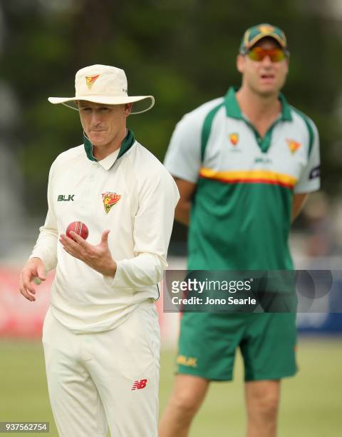 Tasmania player George Bailey looks on with coach Adam Griffith during day three of the Sheffield Shield final match between Queensland and Tasmania...