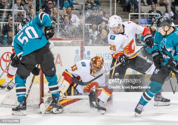 Calgary Flames Center Nick Shore looks for the puck in a goal attempt by San Jose Sharks Center Chris Tierney during the game between the Calgary...