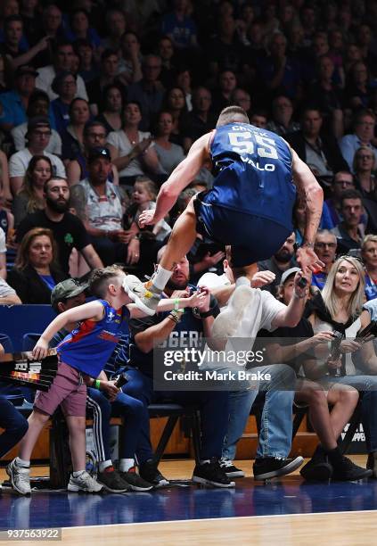 Mitch Creek of the Adelaide 36ers lands in the crowd cahsing a pass during game four of the NBL Grand Final series between the Adelaide 36ers and...